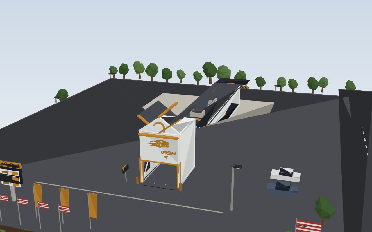 Front view of the remodeled Car Wash Guys — glass-sided wash tunnel and the gold logo tower.