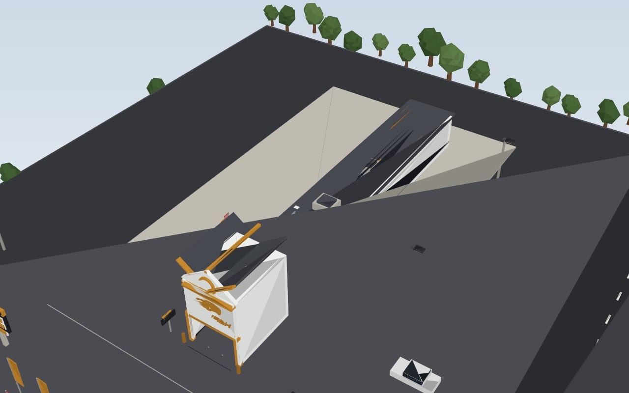 Aerial overview of the whole site — building, lot, vacuums, and landscaping.